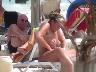 Milf Topless Woman Creams On The Beach