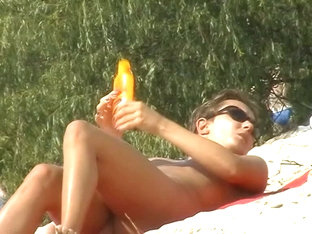 A Luscious Woman Sunbathing In This Nude Beach Voyeur Video