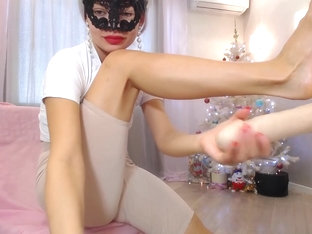 Masked Beauty Wraps Her Sexy Feet Around A Plastic Dick And Rubs It