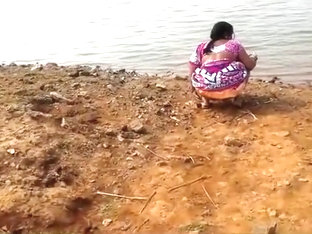 Indian Woman Peeing In The Dirt By A Lake