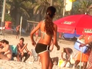 A Voyeur Is Filming A Game Of Volleyball On Beach