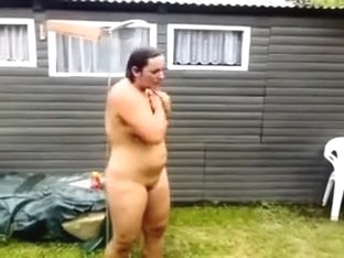 Aged Fat Wife Naked On The Backyard Washing With A Hose