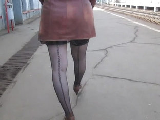 Girl In Seamed Stockings Walking On A Train Station