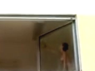 Short Haired Hotty Washes Windows Topless