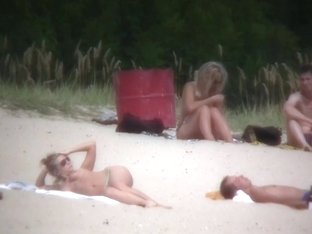 Nude Couples Are Relaxing On A Nudist Beach Here