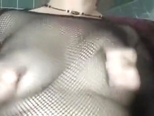 aged wife wearing fishnet squeezes her nipps