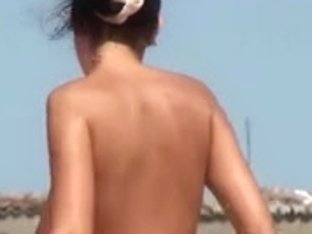 Busty Girl Shows Her Mighty Jugs On A Nudist Beach