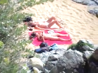 Two Nude Girls Sun Bathing On Beach.